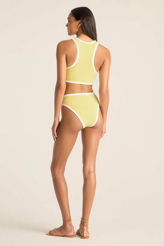 Woman turned away wearing a high neck yellow swim top with matching swim bottoms and white trim